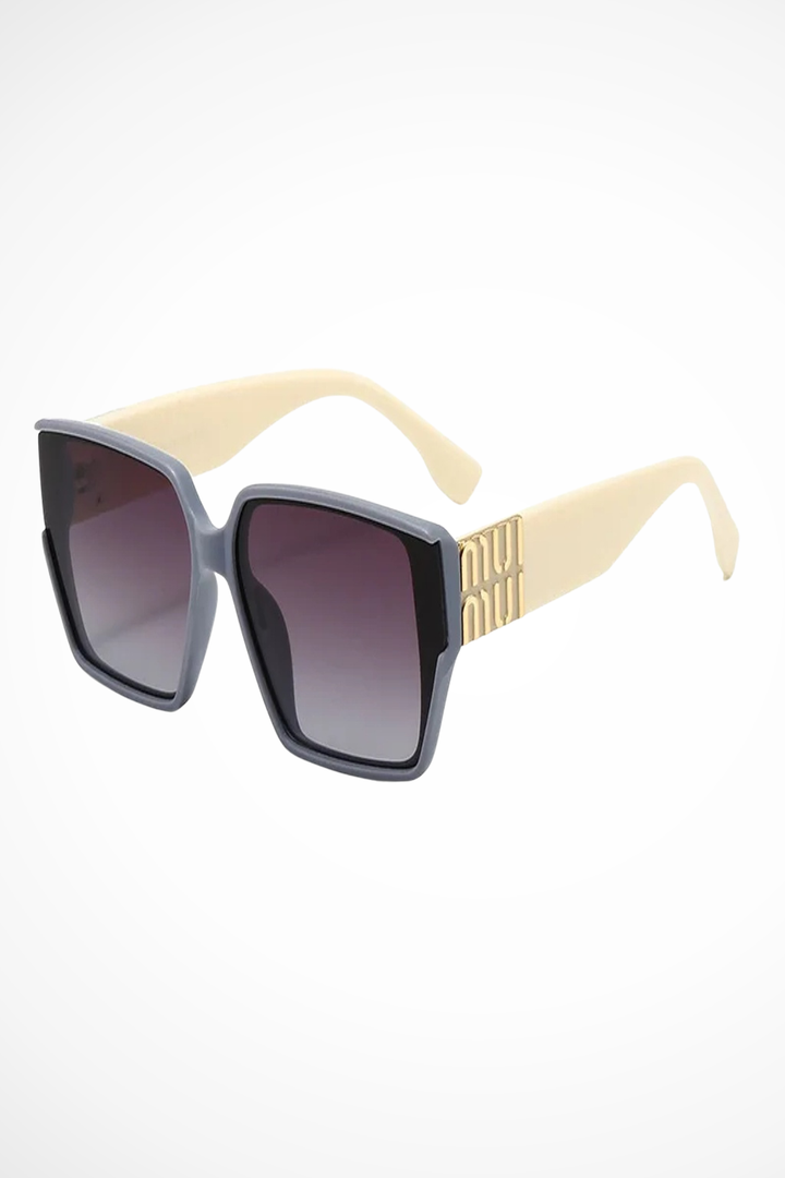 Statement women's oversized square sunglasses with gold detail. Fashion eyewear, tinted lenses.