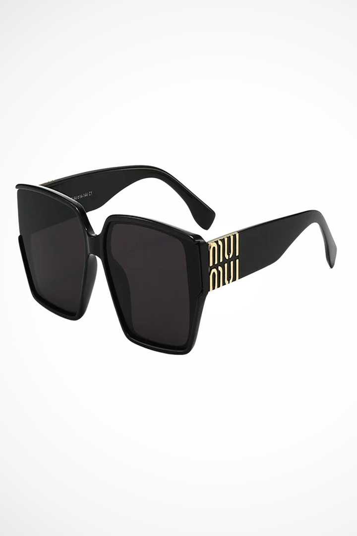 Stylish women's oversized square sunglasses with gold accents. Modern fashion statement eyewear.