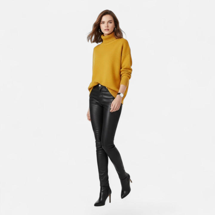 Lifestyle shot: woman styled in a chic oversized turtleneck knit sweater.