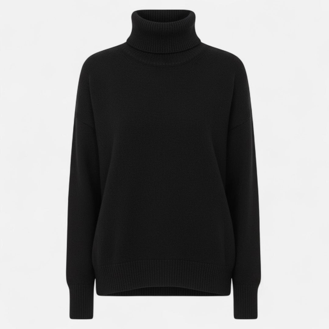 Front view of a women's oversized knit sweater with a comfortable turtleneck.