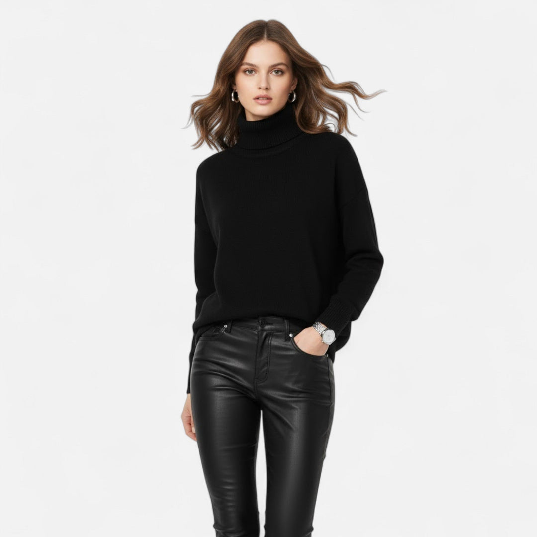 Back view highlighting the oversized drape of this women's turtleneck sweater.