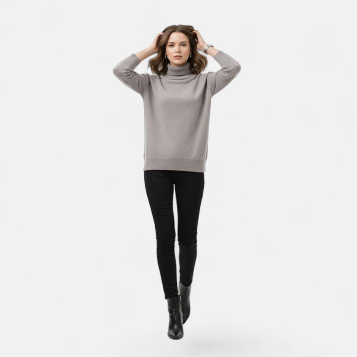 Close-up of the chunky knit texture on a women's oversized turtleneck sweater.