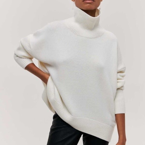 Women's cozy oversized turtleneck sweater, a warm long sleeve jumper for cold weather fashion.