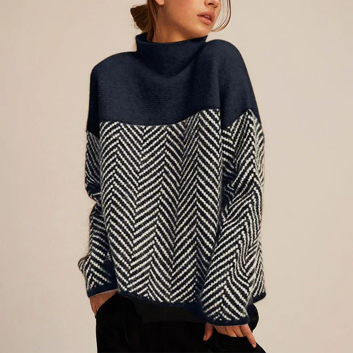 Chic women's oversized turtleneck sweater featuring a vibrant color block chevron design. Comfortable & elegant winter wear.