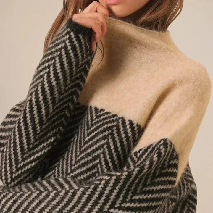 Women's oversized turtleneck chevron sweater; a chic, comfortable, long-sleeve top with a modern color block pattern.
