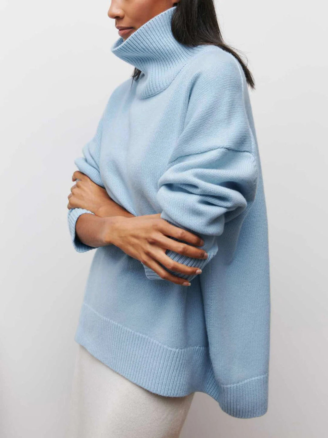 Stylish ladies long sleeve oversized turtleneck sweater, featuring unique elbow slits for casual wear.