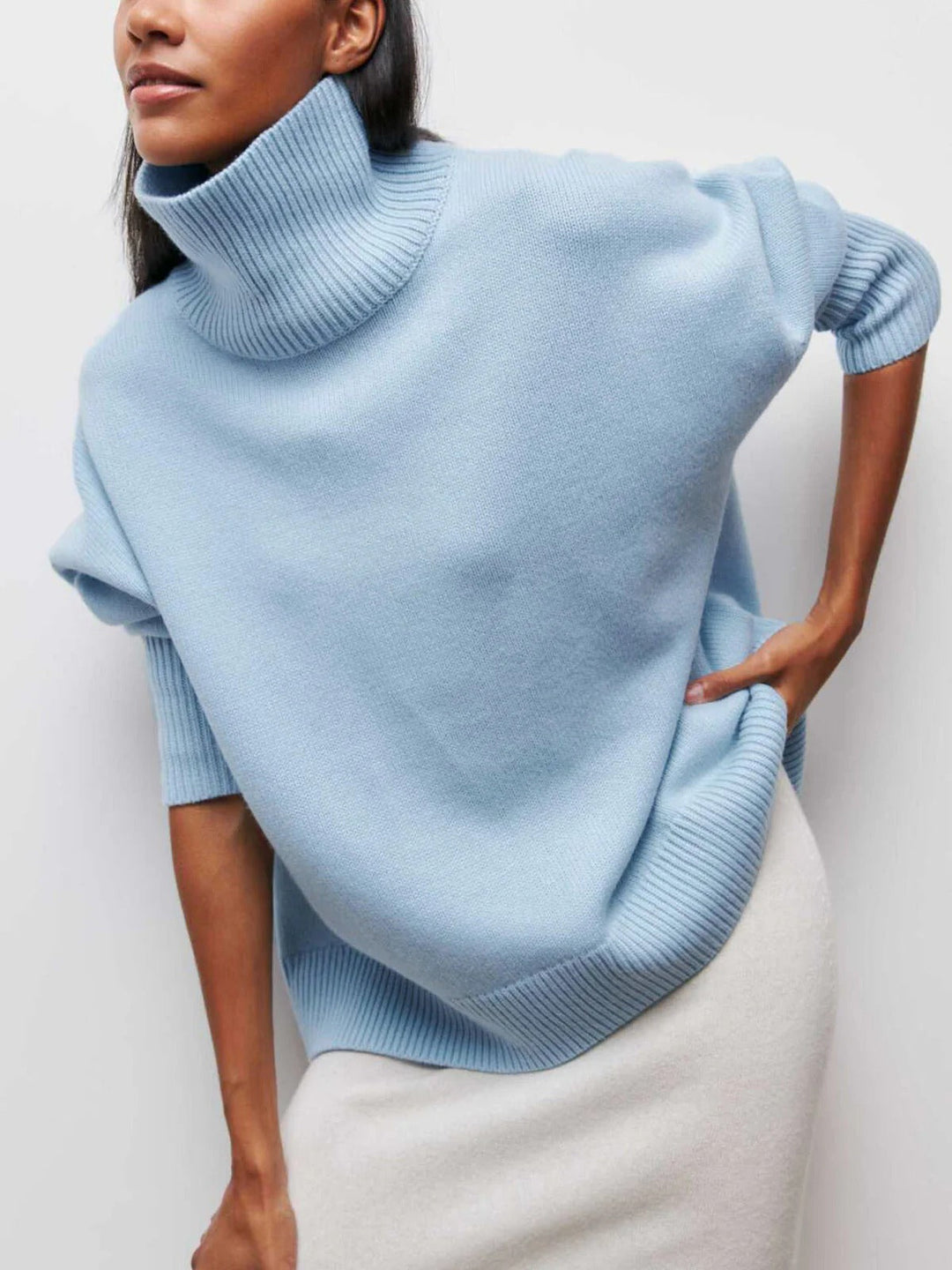 Cozy women's oversized turtleneck sweater, a warm winter top with modern elbow slits.