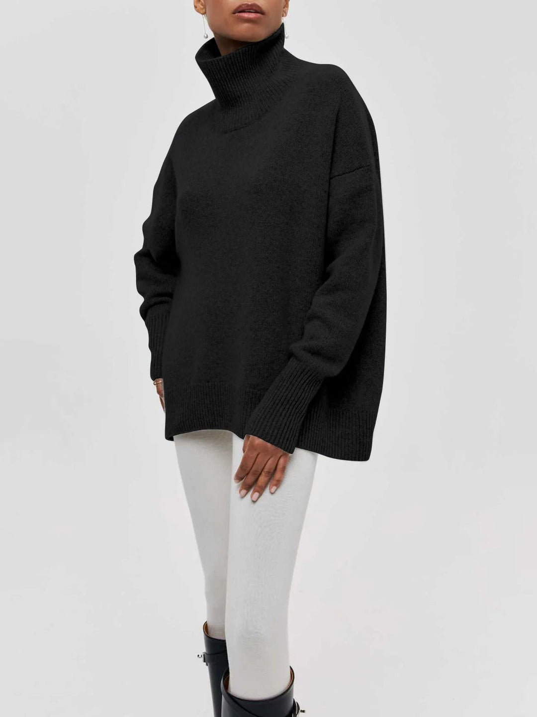 Elegant women's oversized turtleneck sweater, a stylish and warm top with modern elbow slits design.