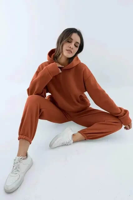 Trendy women's two-piece oversized tracksuit. Sporty fashion hoodie and joggers for casual style and activewear.