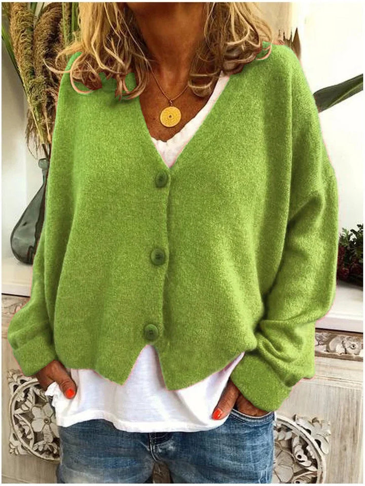 V-neck oversized women's cardigan sweater with prominent buttons, ideal for comfortable plus size layering.