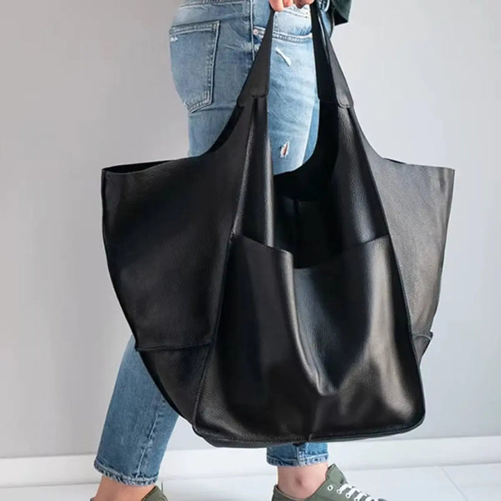 Modern women's oversized tote, crafted from high-quality vegan leather.
