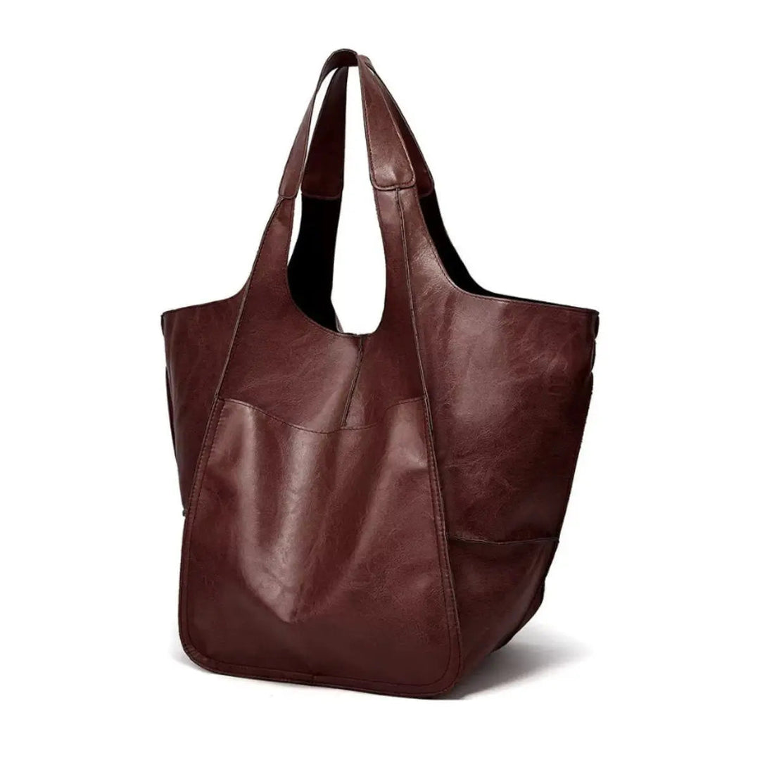 Chic women's travel tote in oversized vegan leather, perfect for getaways.