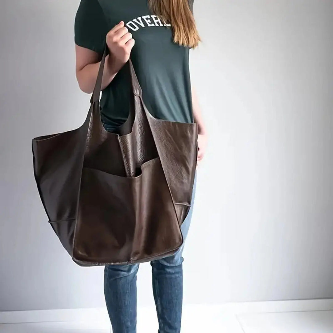 Fashionable women's oversized shoulder bag in sleek vegan leather.