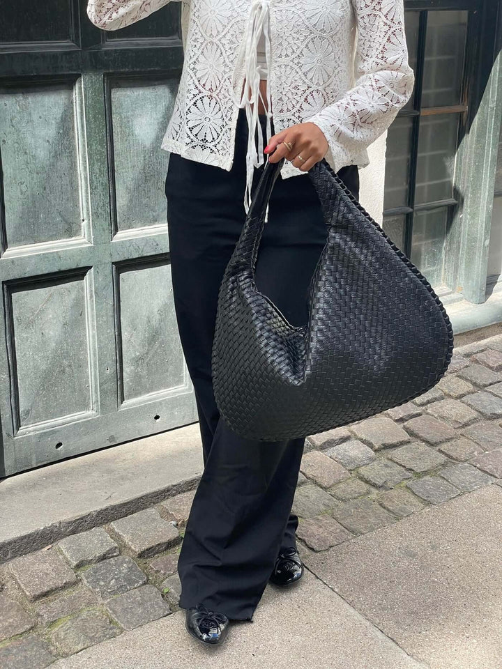 Minimalist oversized tote bag for women, woven texture, perfect for travel.