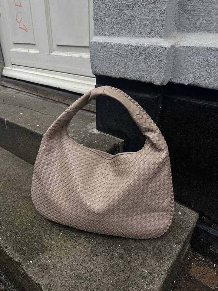 Stylish oversized shoulder bag, woven finish, perfect for women's travel needs.