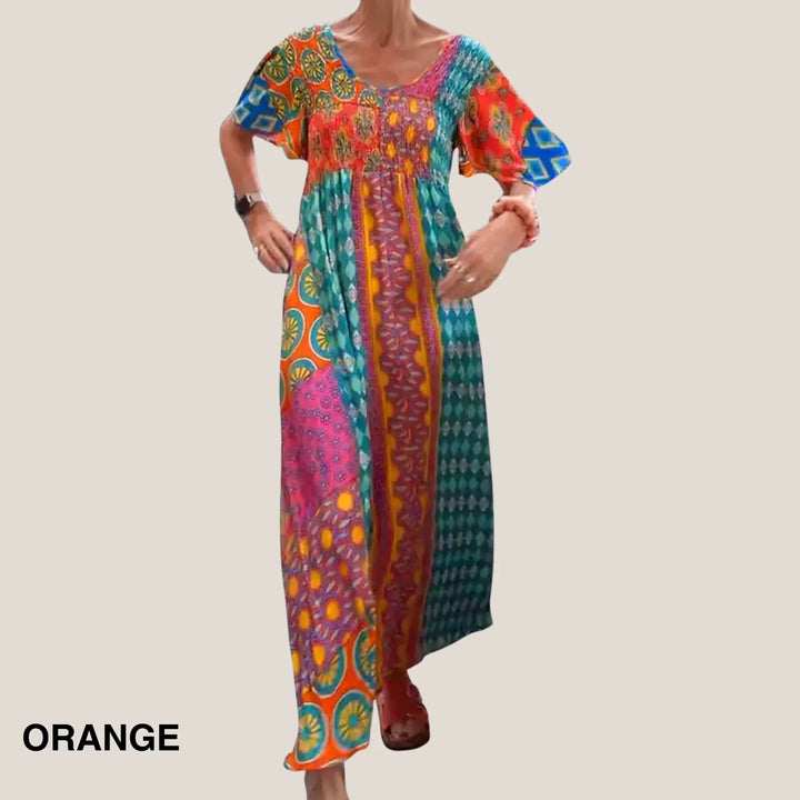 Women's paisley patchwork midi dress with V-neck, short sleeves, and smocked waist. Elegant summer style.