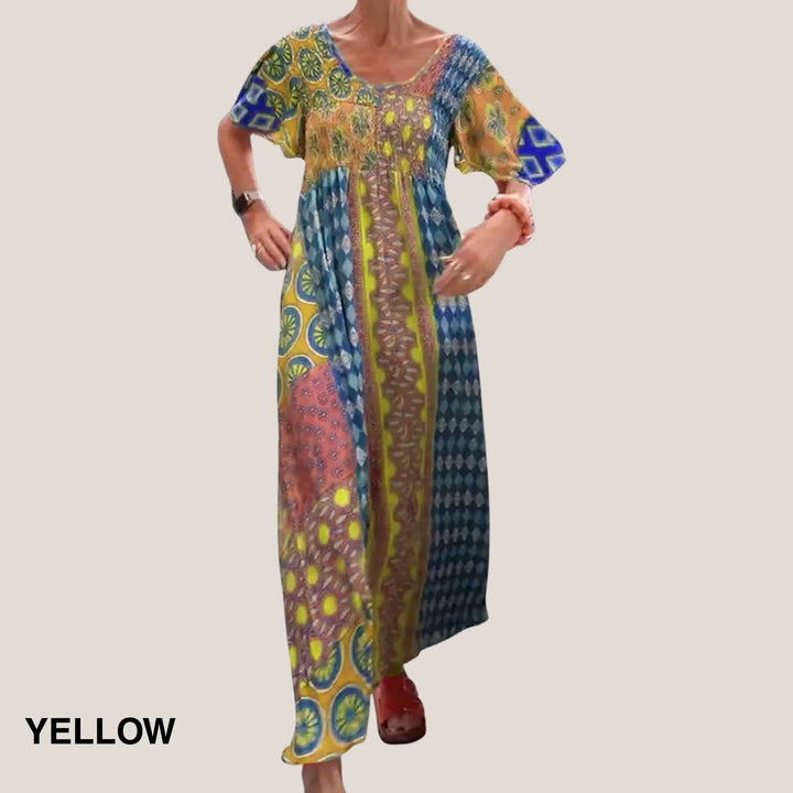 Vibrant paisley patchwork midi dress for women. Features a flattering V-neckline, short sleeves, and a smocked waist.