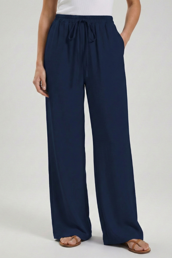 Palazzo trousers for women. Wide-leg, flowy, with a drawstring waist and side pockets. Casual summer wear.