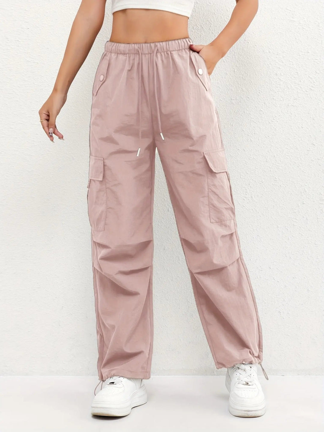 Women's parachute cargo trousers with drawstring waist & relaxed fit, perfect for streetwear style.