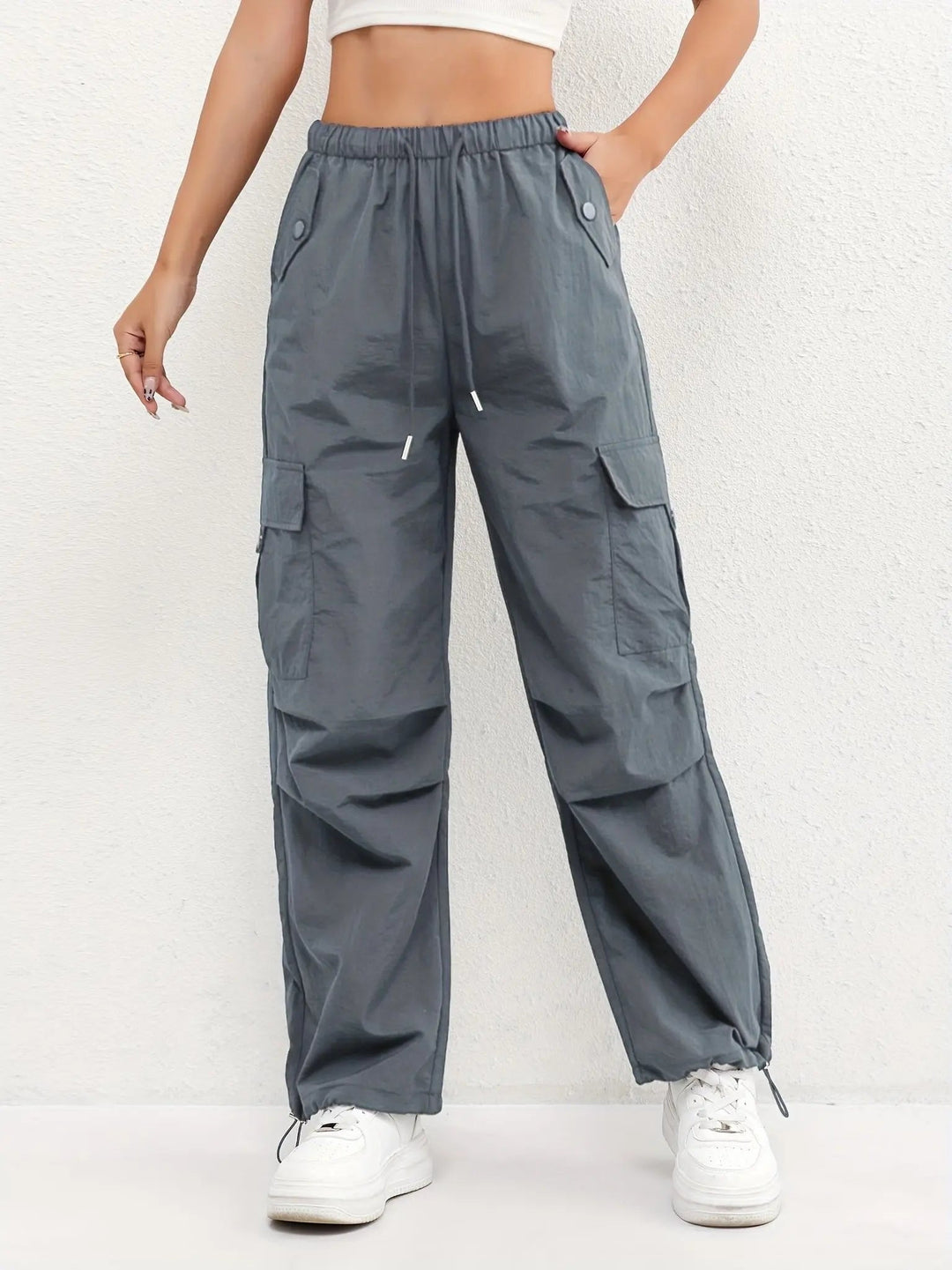 Women's drawstring waist parachute cargo trousers, ideal for casual fashion with adjustable hem detail.