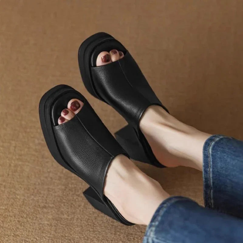 Open-back women's mule sandals, featuring a modern peep-toe and comfortable platform block heel.