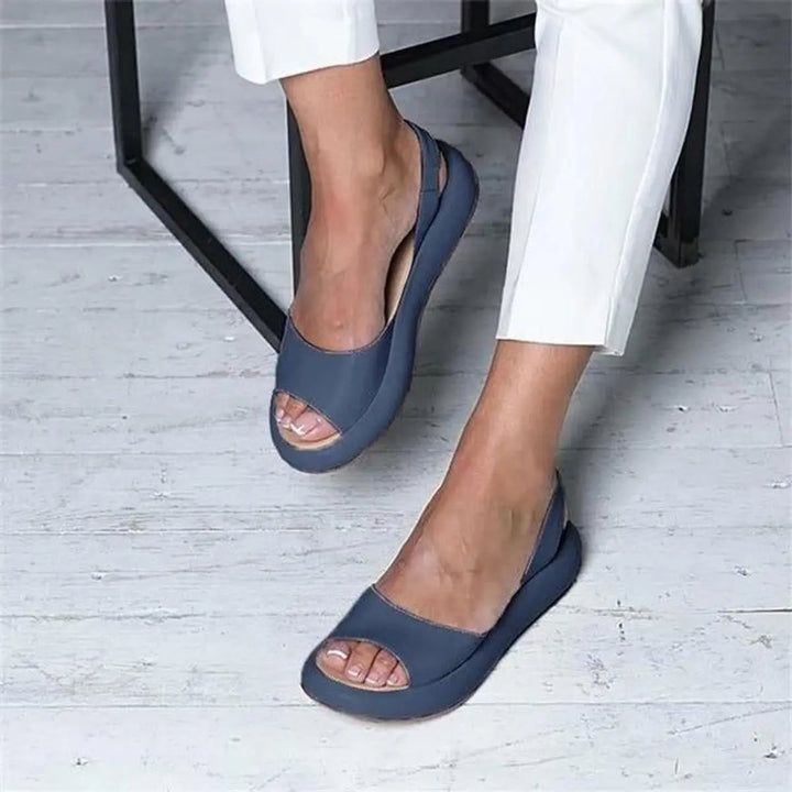 Casual women's peep toe flat sandals with slingback strap, perfect for summer comfort.
