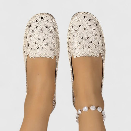 White comfortable women's perforated slip-on flats. Breathable, closed-toe casual shoes for versatile style.