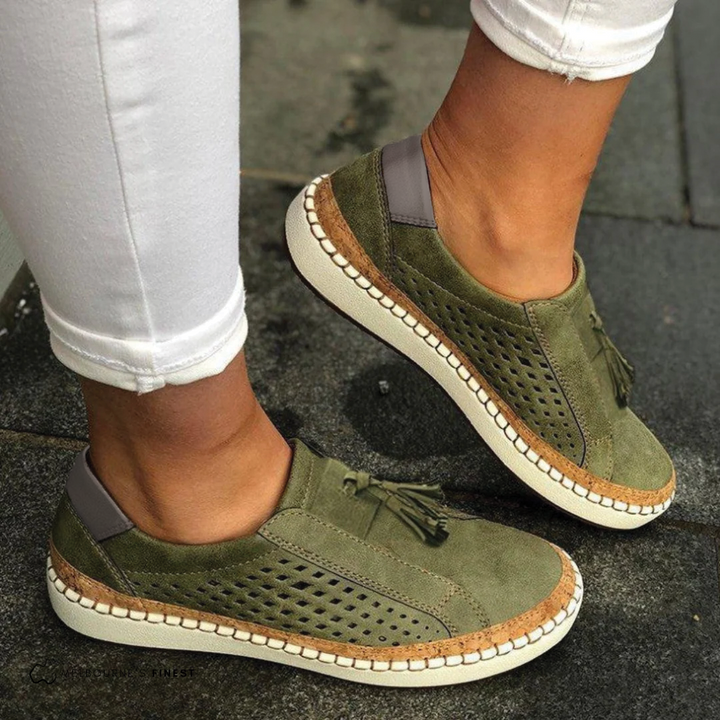 Women's perforated slip-on shoes in white, offering breathable comfort.