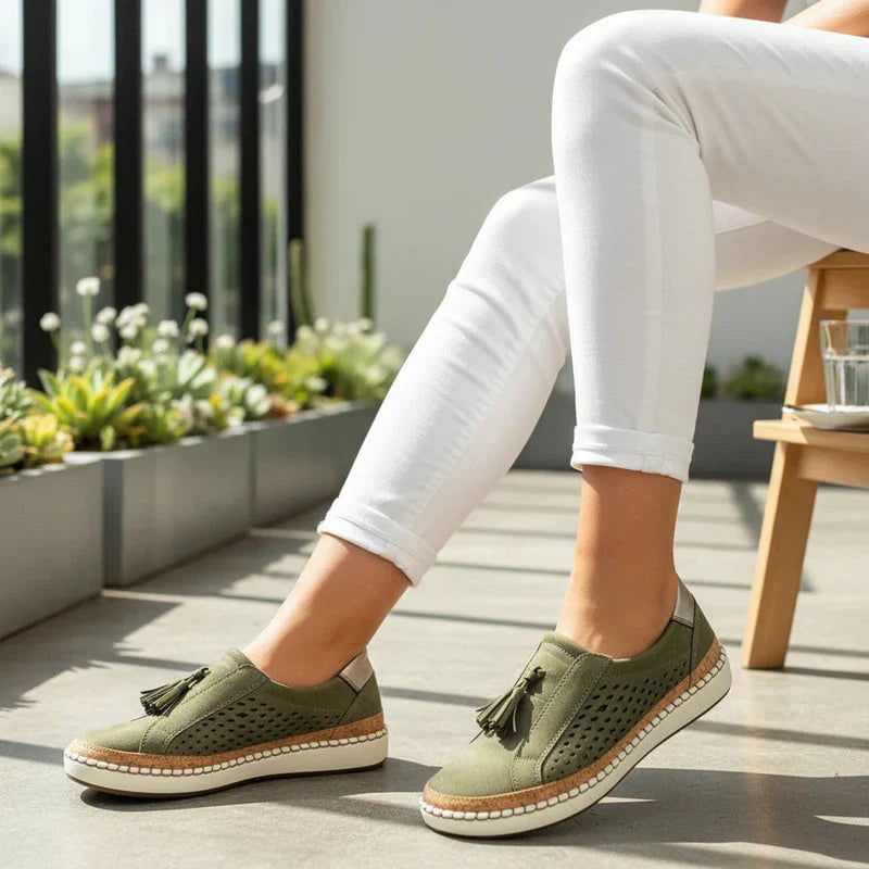 Close-up of the breathable perforated vegan leather on women's slip-on shoes.