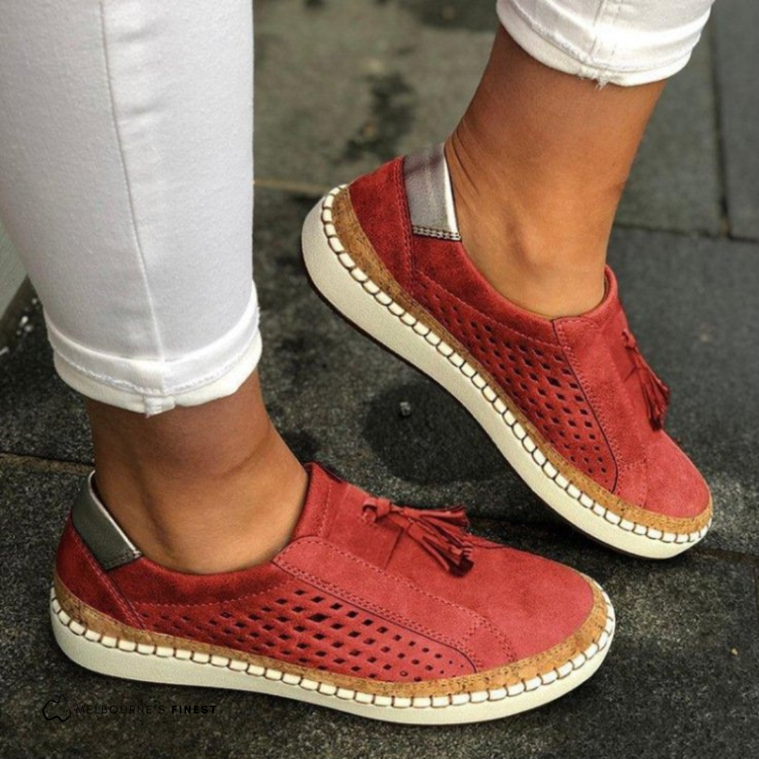 Tan women's perforated slip-on shoes, a versatile and comfortable casual option.