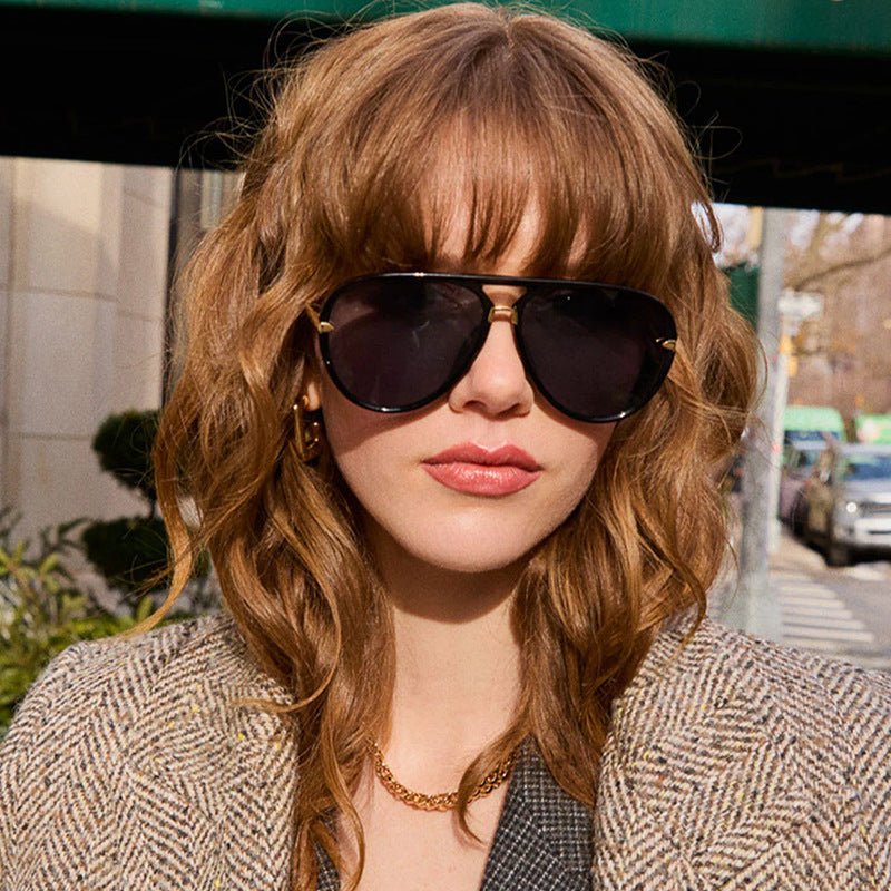 Women's pilot sunglasses with sleek black frame & advanced UV protection, modern eyewear for summer.