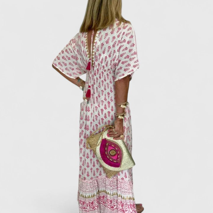 Women's pink boho maxi dress. Comfortable, flowy, and elegant for summer casual wear or a beach vacation outfit.