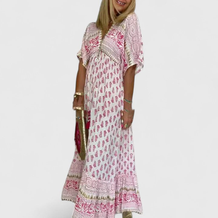Comfortable women's printed boho maxi dress. Flowy long pink summer dress for elegant casual wear or beachwear.