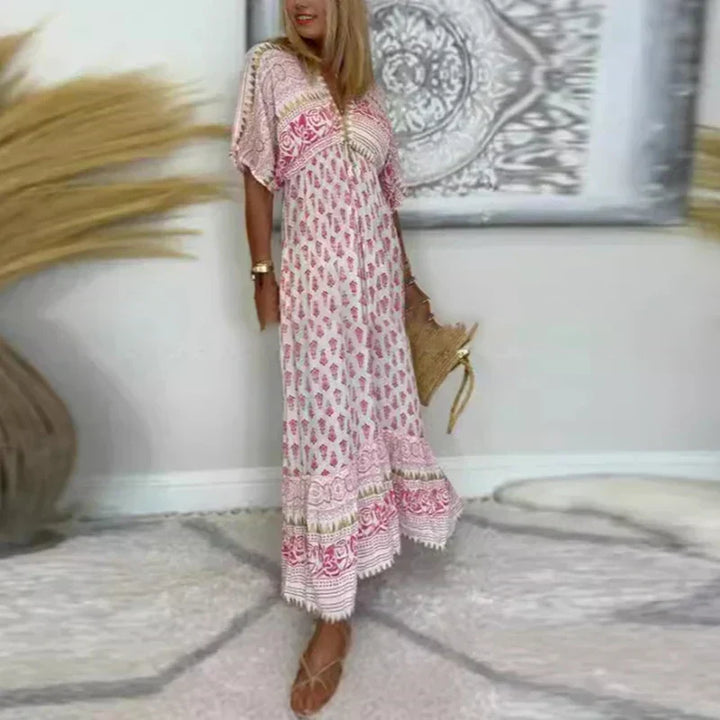Flowy bohemian printed maxi dress for women, featuring a V-neck and short sleeves, ideal for casual spring/summer.