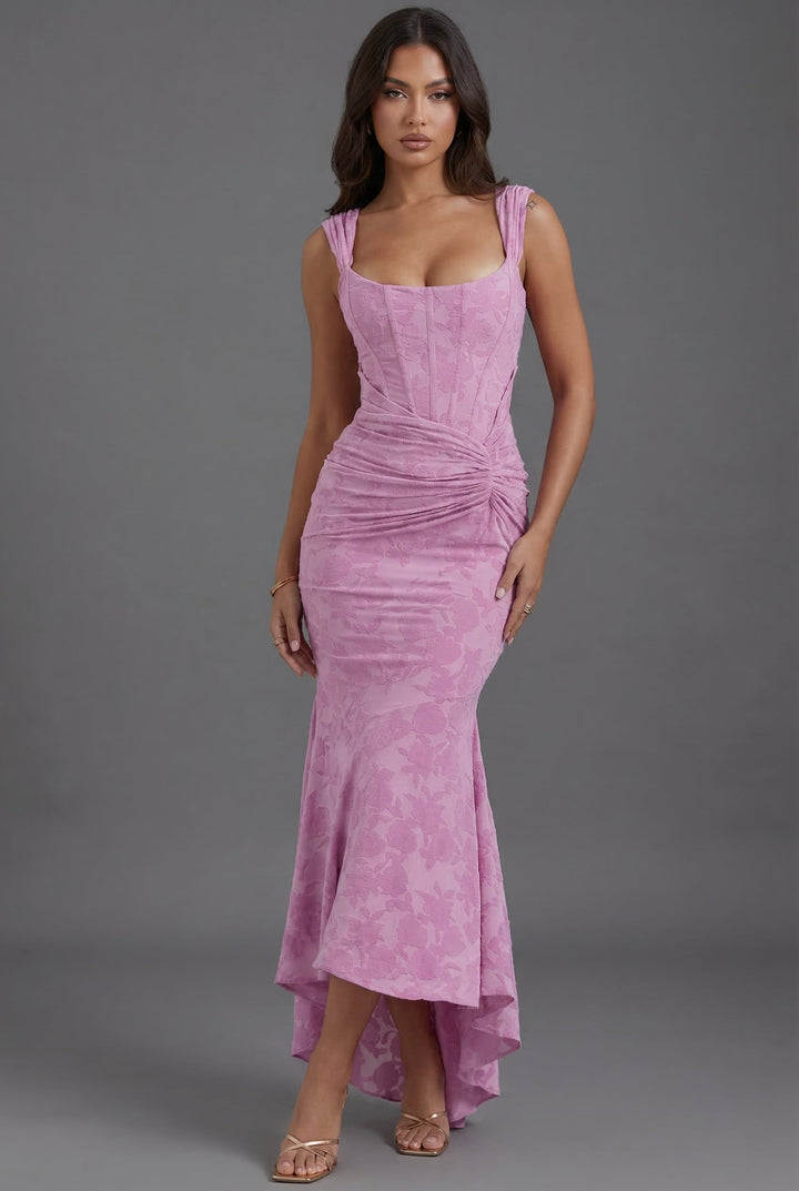 Women's pink corset maxi dress with elegant ruched detailing and a dramatic fishtail hem.