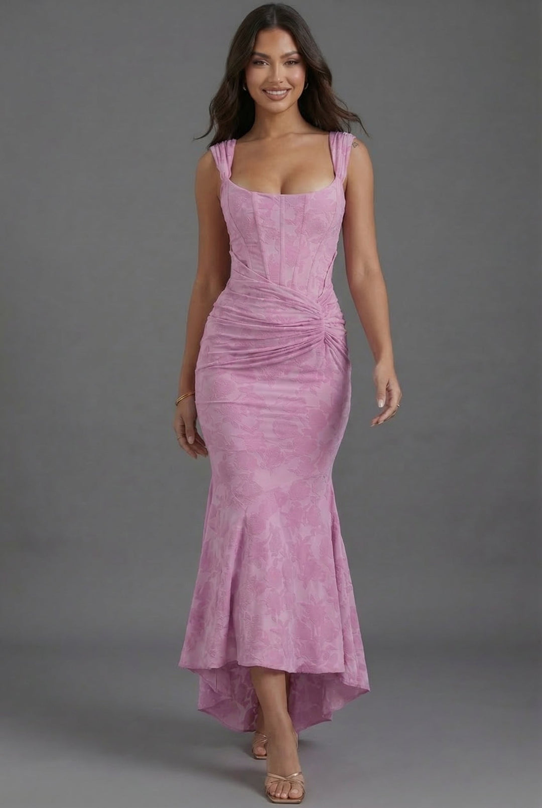 Special occasion pink ruched maxi dress with a stylish corset top and a sophisticated fishtail hem.