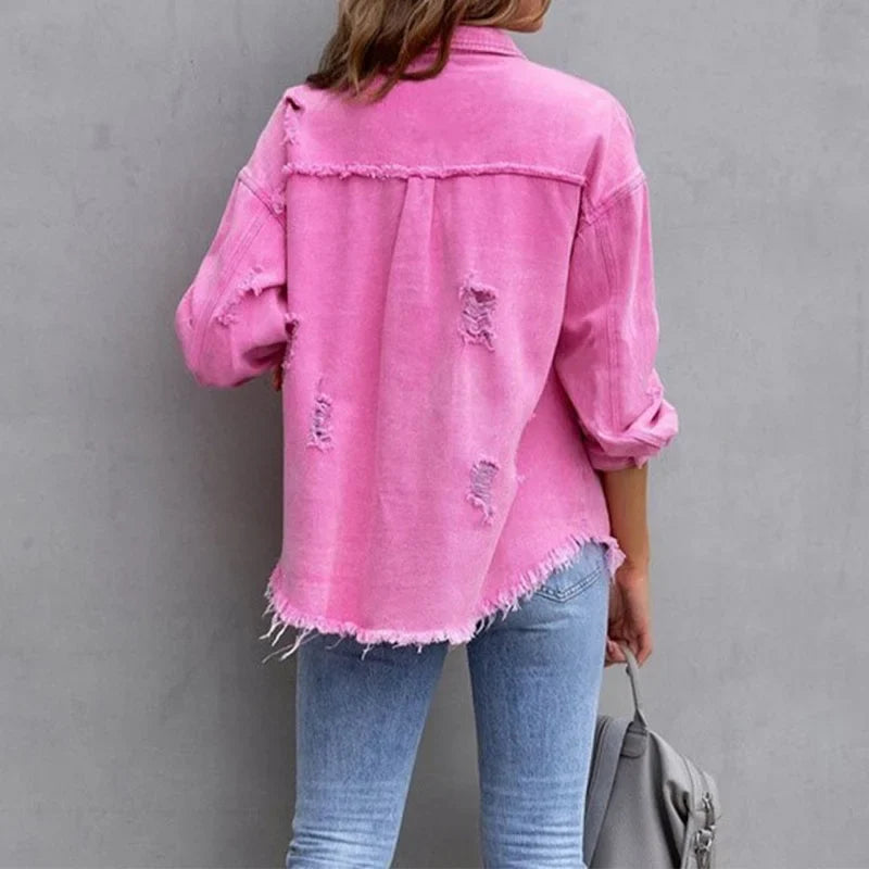 Stylish women's pink distressed denim jacket, featuring frayed edges & button-up closure for a modern casual look.
