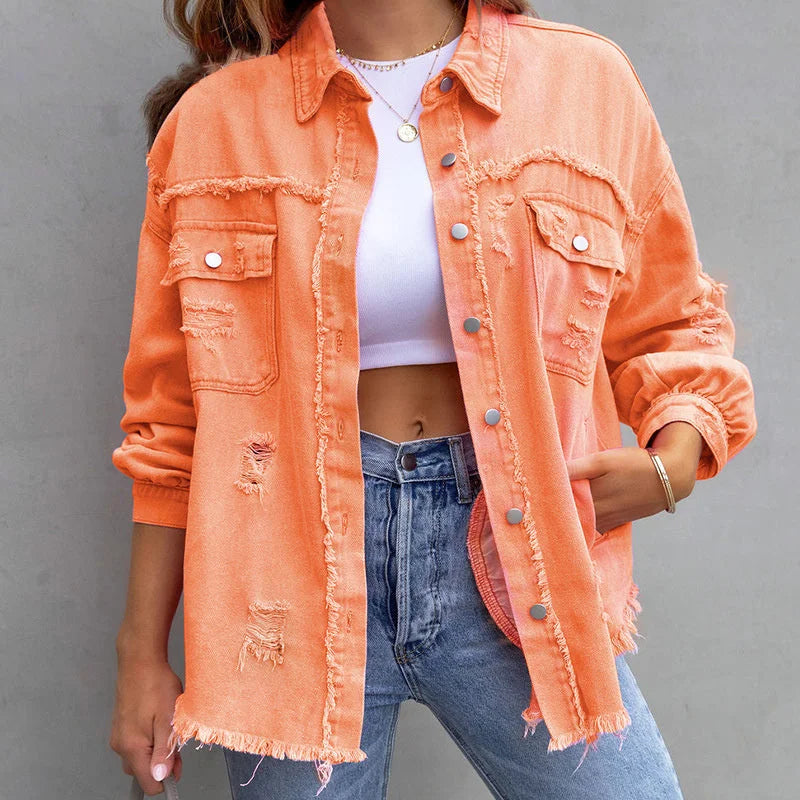 Pink distressed denim jacket for women, designed with a button-up front & stylish frayed edges for casual wear.
