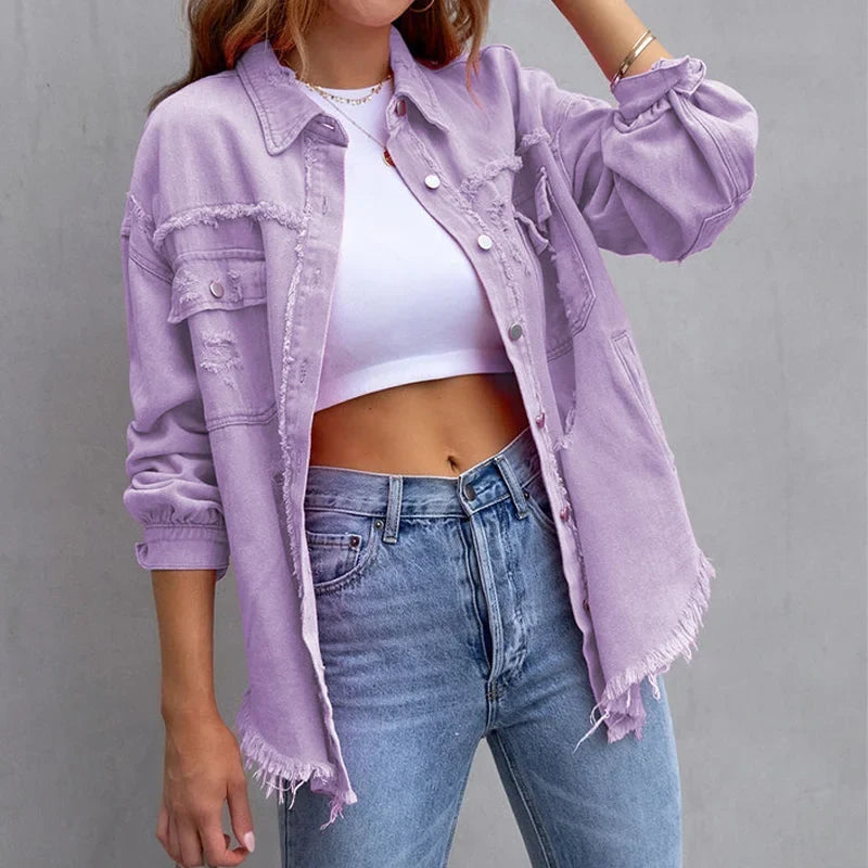 Pink distressed women's denim jacket with frayed hem & button-up closure. Ideal casual spring/fall fashion.