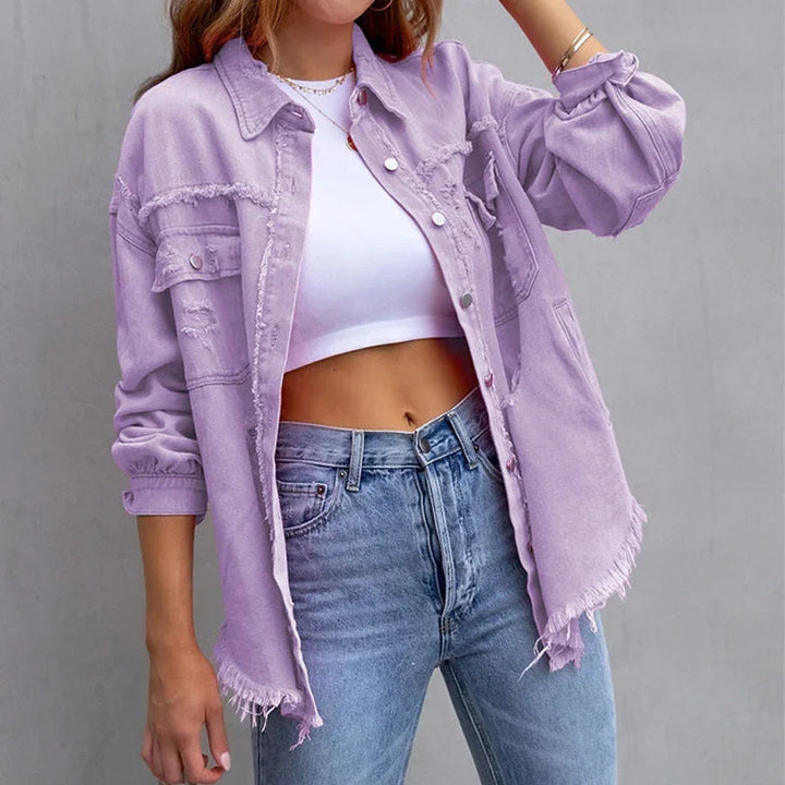 Pink distressed women's denim jacket with frayed hem & button-up closure. Ideal casual spring/fall fashion.