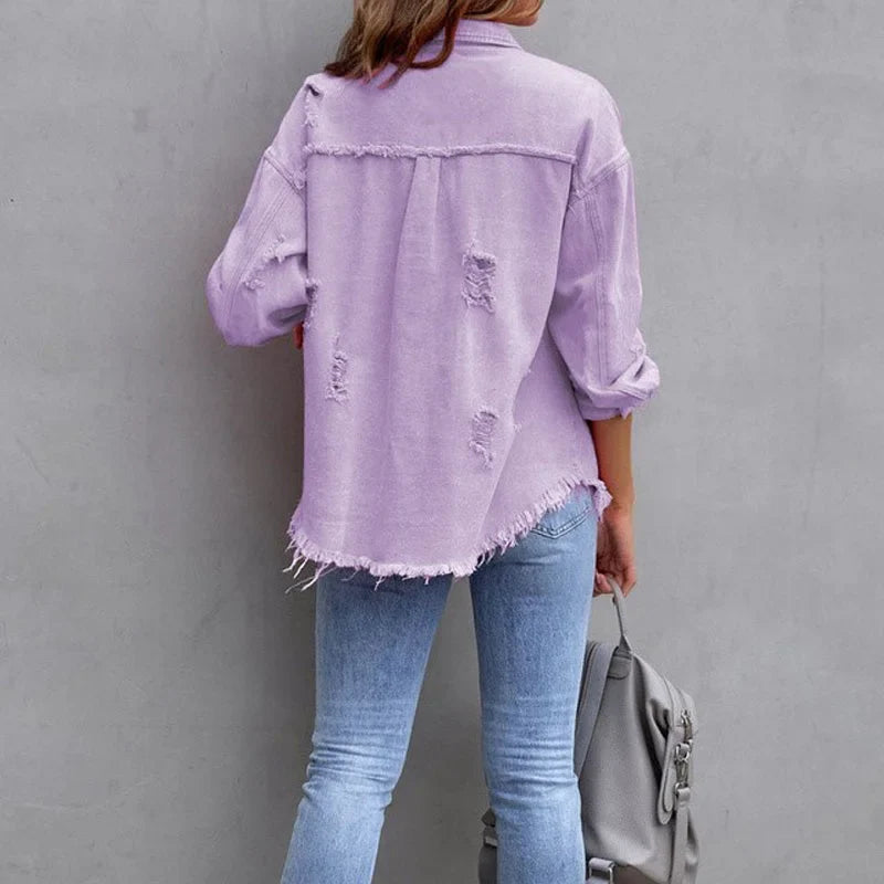 Trendy women's pink distressed button-up denim jacket with frayed edges, great for casual spring/fall fashion.