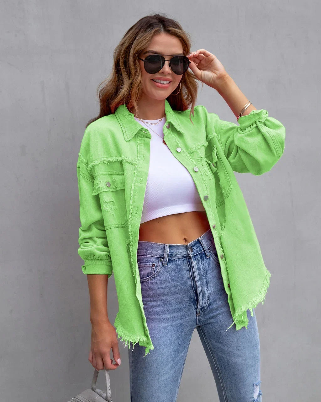 Casual women's pink denim jacket, distressed style with frayed hem, classic button-up for stylish outerwear.