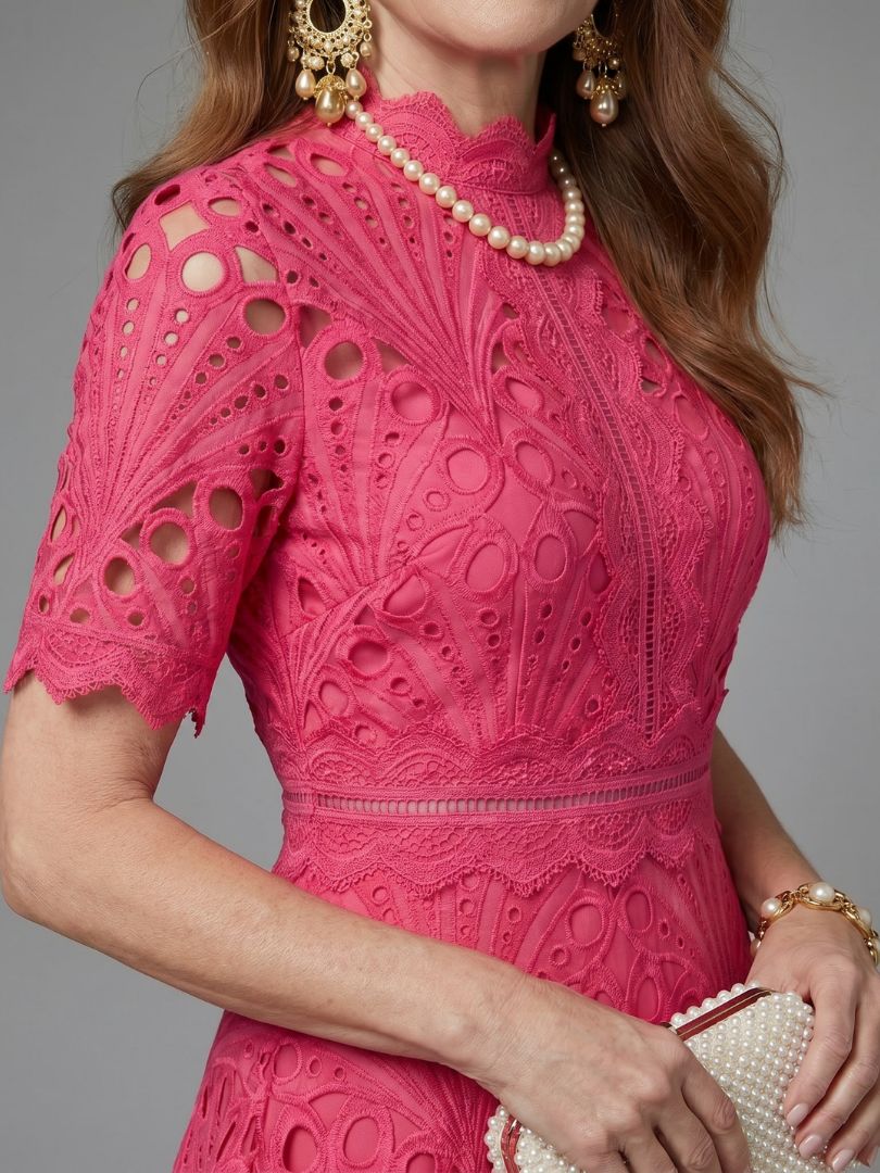 Comfortable women's pink midi dress with delicate eyelet lace and short sleeves, designed with a fitted waist.