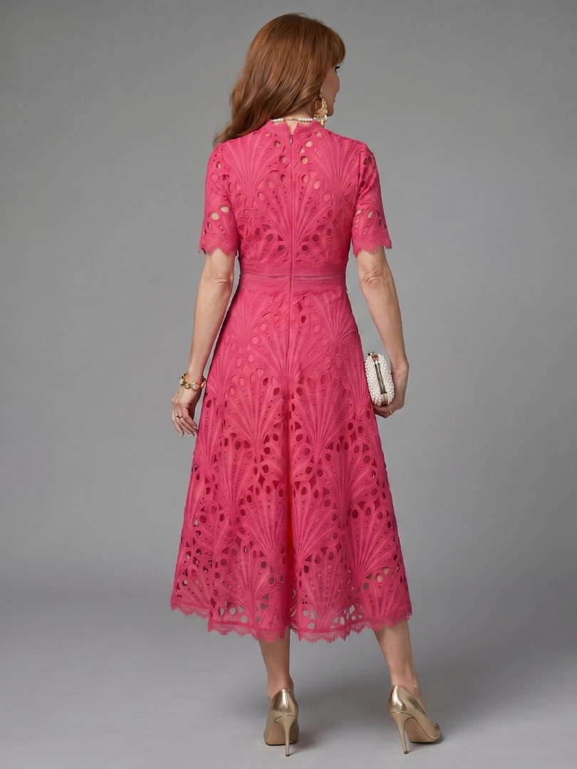 Stylish women's pink eyelet lace midi dress, short sleeve and fitted waist, ideal for spring and summer outfits.