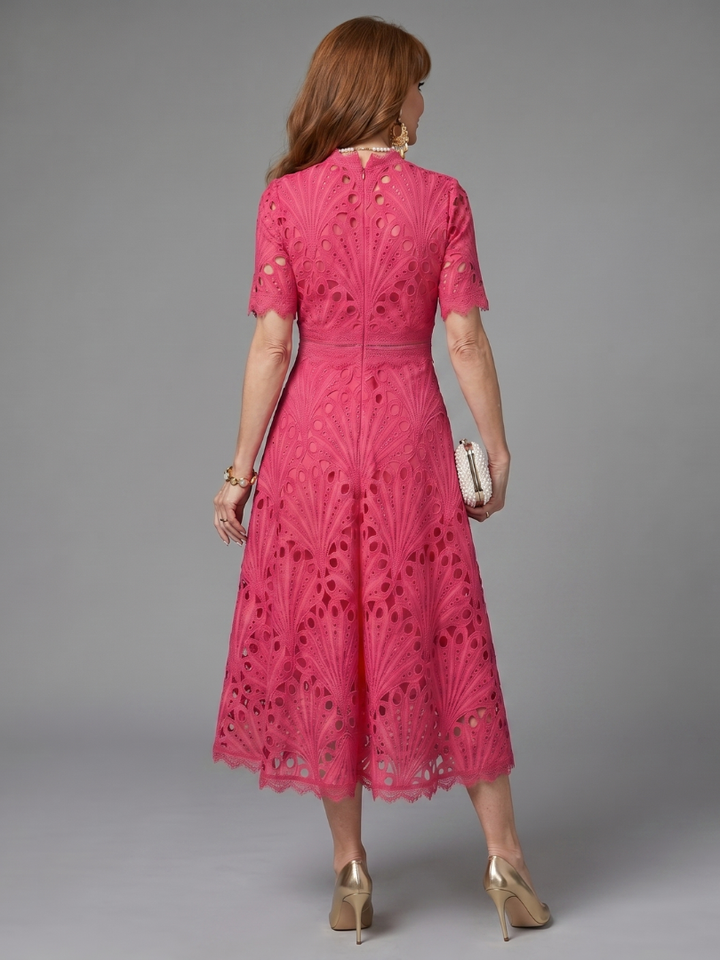 Stylish women's pink eyelet lace midi dress, short sleeve and fitted waist, ideal for spring and summer outfits.