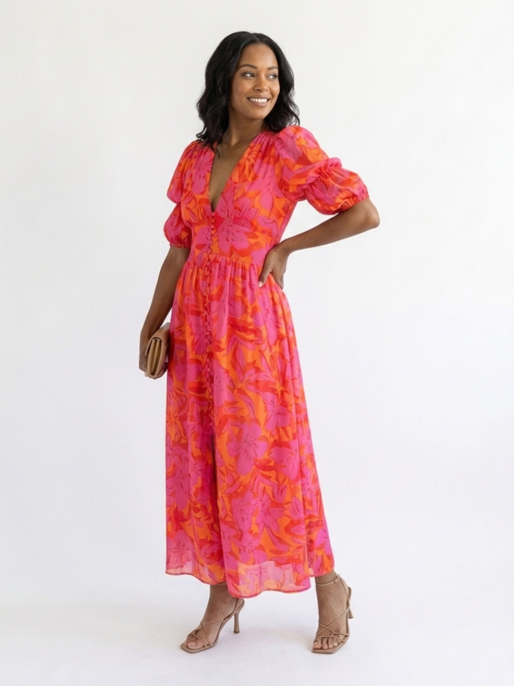 Relaxed fit women's floral midi dress with V-neck and puff sleeves. Comfortable pink dress for casual spring wear.