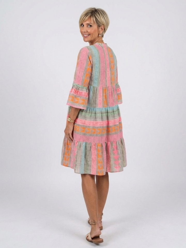 Stylish women's geometric print V-neck tiered knee-length dress. Vibrant pink casual dress, great for women's fashion.