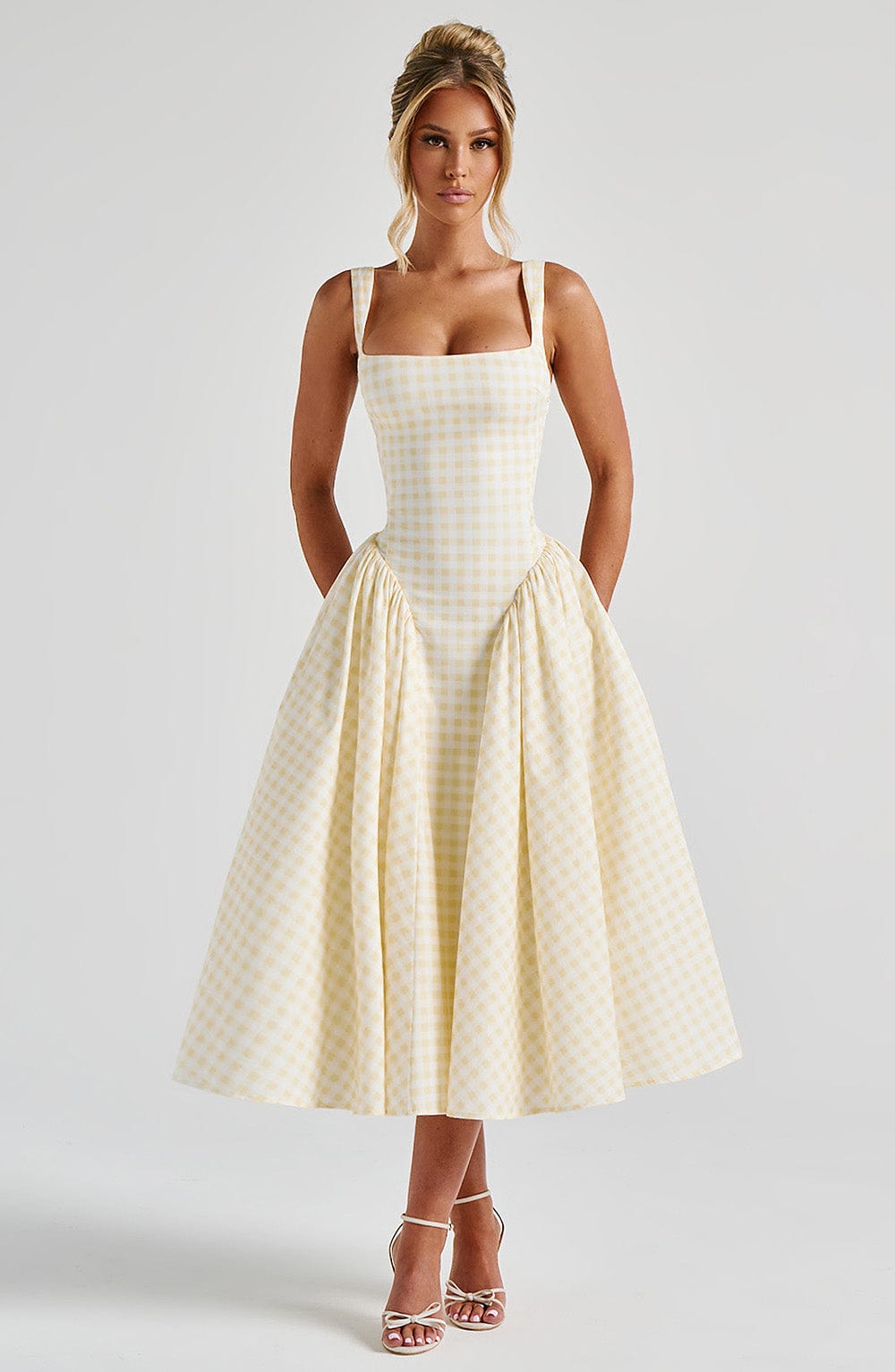 Chic women's square neck sleeveless midi dress in classic gingham print, ideal for a stylish summer outing.