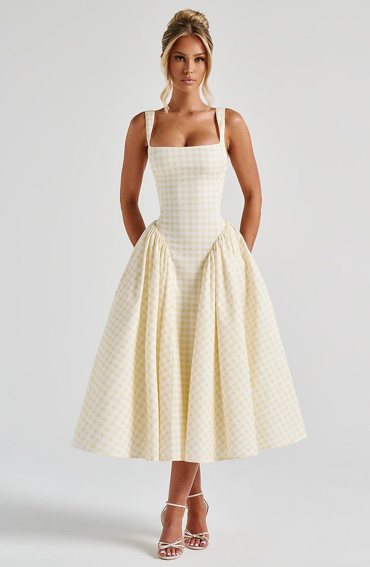Chic women's square neck sleeveless midi dress in classic gingham print, ideal for a stylish summer outing.
