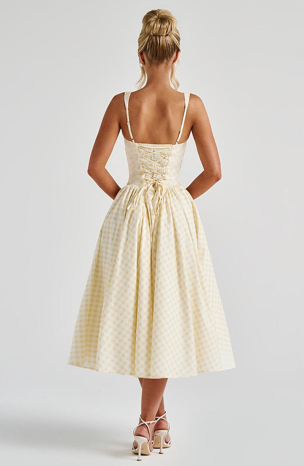 Beautiful women's midi dress with square neck, sleeveless design, and fashionable gingham pattern for everyday wear.